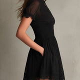 Sigrun — Black Smocked Mini Dress with Sheer Sleeves and Lace-Trim Hem