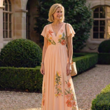 Melusine — Peach Pleated Maxi Dress with Floral Detail and Flutter Sleeves